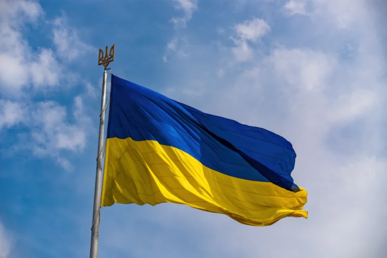 Ukrainian flag flying in the sky to represent changes to the Ukraine Scheme