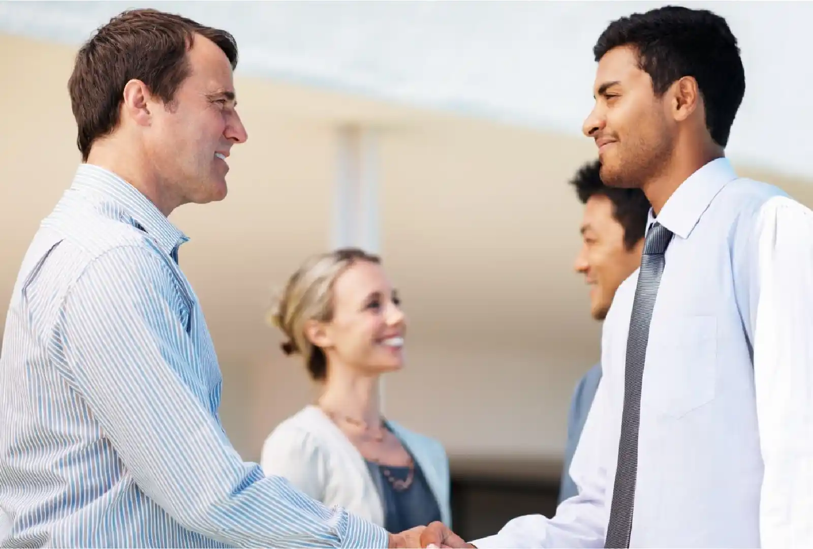 Business Immigration - Office workers shaking hands