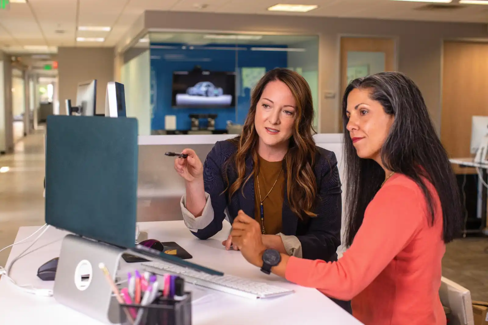 Business Immigration - Two woman working on a laptop