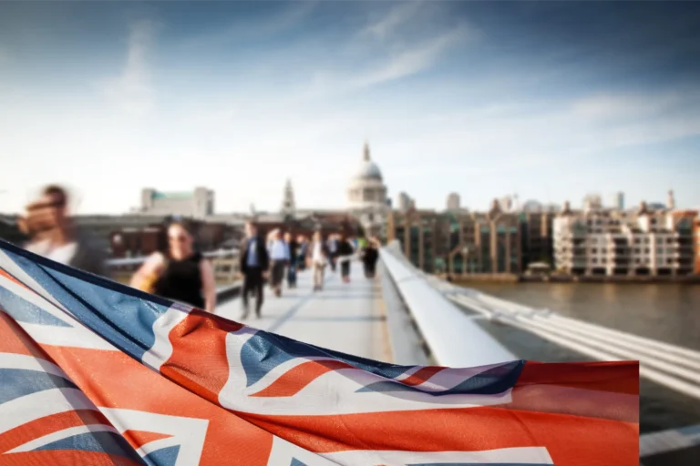 Union Jack flying on the bottom half of the screen on Westminster Bridge, leading to Parliament where 2023 immigration rules were made